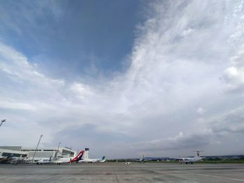 Airplane on runway against sky