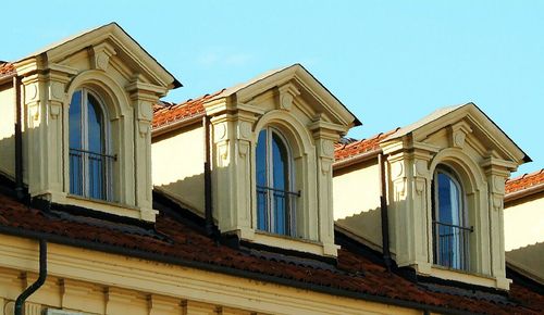 Low angle view of historic building against clear blue sky