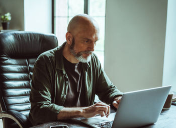 Young man using laptop at home