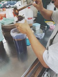 Midsection of man preparing food at home