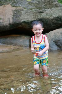 Happy boy walking in lake