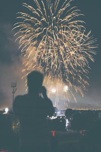 Firework display in city at night