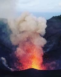 Aerial view of volcanic mountain against sky