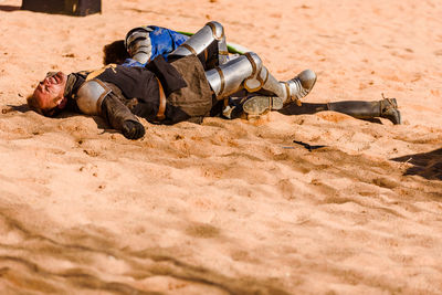 Man lying down on sand