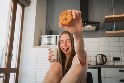 Young woman sitting at home