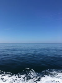 Scenic view of sea against clear blue sky