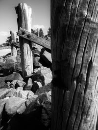 Close-up of wooden post against sky