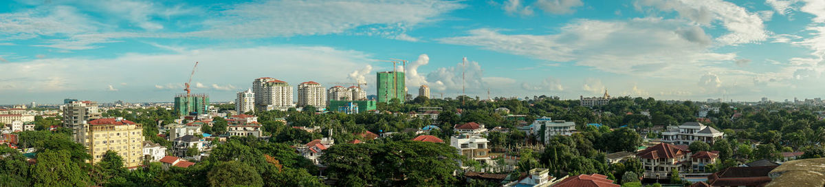 Panoramic view of modern buildings in city against sky