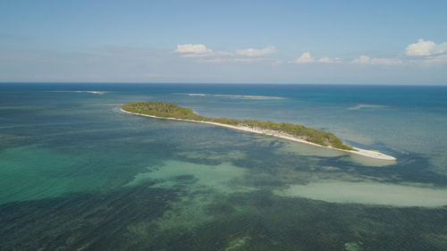 Tropical island with white sandy beach, palm trees. anduyong island with colorful reef. 