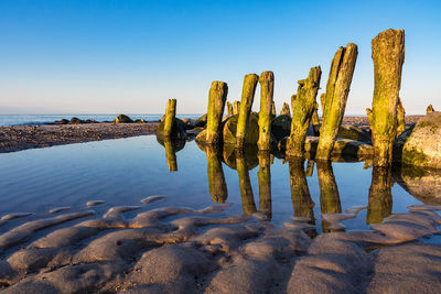 Panoramic view of beach against clear blue sky