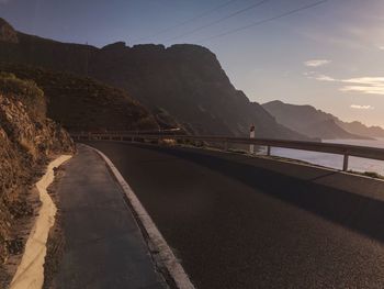 Road by mountain against sky