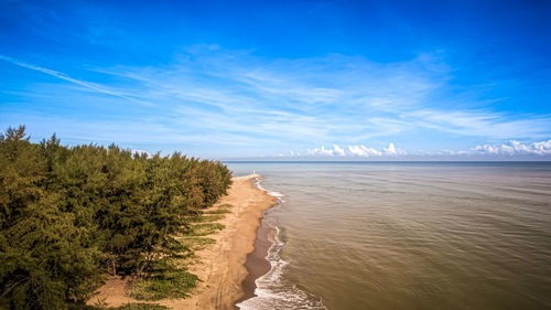 Scenic view of beach against blue sky