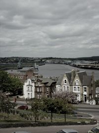 Buildings against cloudy sky