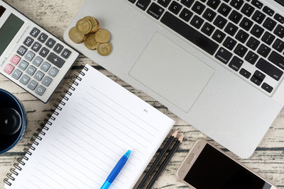 High angle view of laptop and book on table