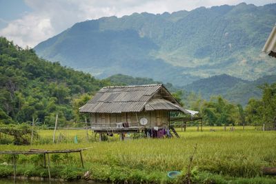 Built structure on field against mountains