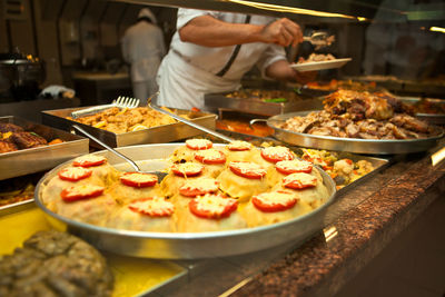 Midsection of chef preparing food in restaurant