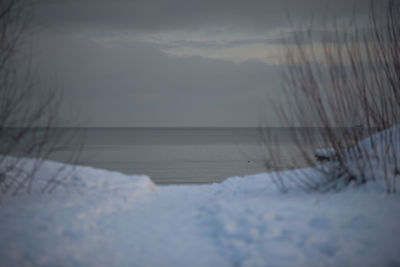 Scenic view of frozen lake against sky