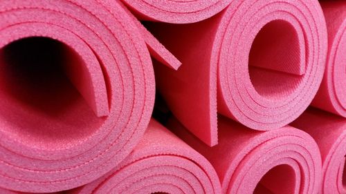 Close-up of pink exercise mat rolled up