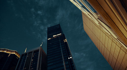 Low angle view of modern buildings against sky at night