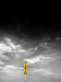 Low angle view of road sign against sky
