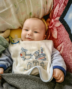 Smiling cute baby lying on bed