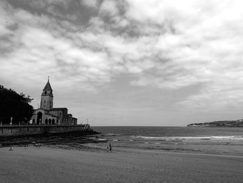 Church by sea against sky