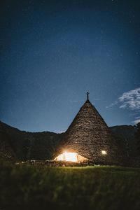 Illuminated built structure against clear sky at night