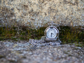 Close-up of clock on stone wall