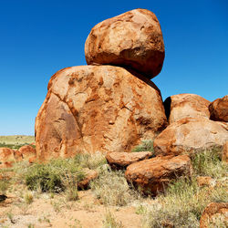 Rock formation against clear blue sky