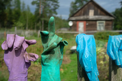 Close-up of hand holding umbrella on field against building