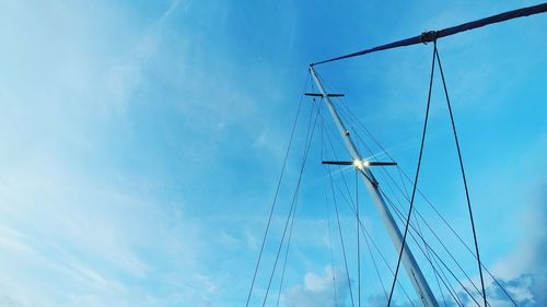 Low angle view of sailboat against blue sky