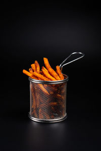 Close-up of drink in jar against black background