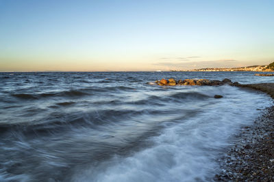 Scenic view of sea against clear sky during sunset