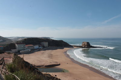 Scenic view of beach against blue sky