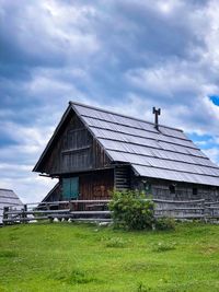 Built structure on field against sky