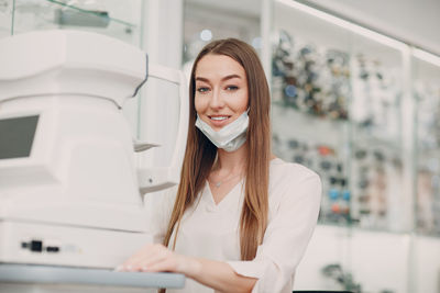 Portrait of a smiling young woman at lab