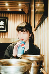 Portrait of woman drinking coffee in restaurant