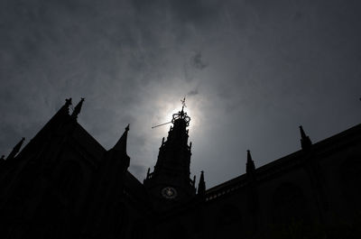 Low angle view of building against cloudy sky