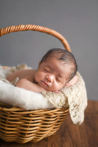 Portrait of cute baby boy in basket