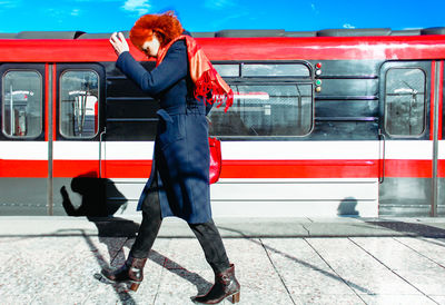 Full length of train standing on railroad station platform