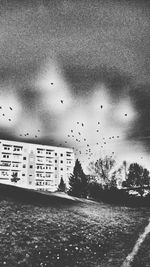 Buildings against sky seen through window