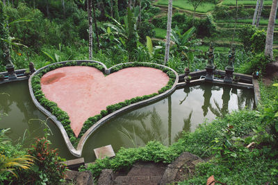 High angle view of heart shape by trees in lake