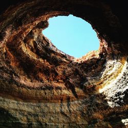 Low angle view of hole in tunnel