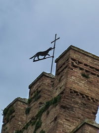 Low angle view of weather vane against clear sky