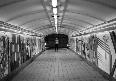 Full length of man standing on subway station
