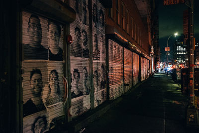 Street amidst illuminated buildings in city at night