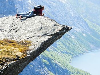 Man lying on rocky mountain