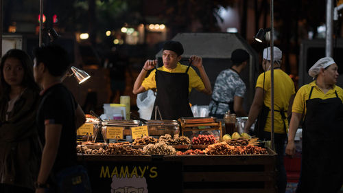 People at market stall in city