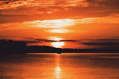 Scenic view of sea against orange sky