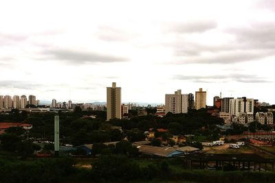 Buildings against cloudy sky